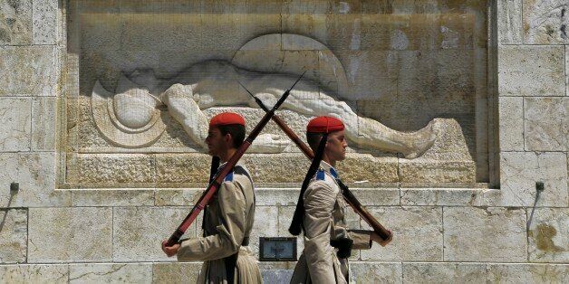 Evzones of Greek Presidential Guards are seen during changing of the guard at the tomb of the unknown Soldier outside the parliament in central Athens, on Thursday, July 2, 2015. Greece braced for more chaos on the streets outside its mostly shuttered banks Thursday, as Athens and its creditors halted talks on resolving the country's deepening financial crisis until a referendum this weekend. (AP Photo/Petros Karadjias)