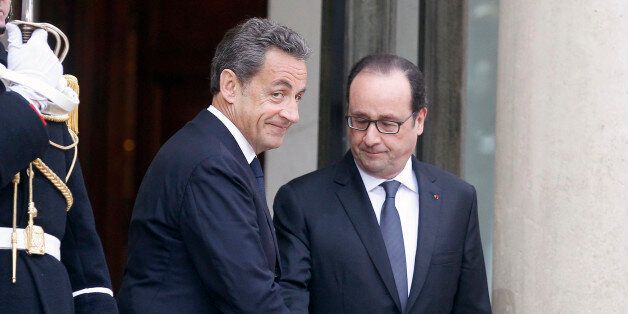 PARIS, FRANCE - JANUARY 08: French President Francois Hollande (R) welcomes France's former President and leader of the right-wing UMP party Nicolas Sarkozy at the Elysee Palace on January 8, 2015 in Paris, France. Twelve people were killed yesterday including two police officers, as two gunmen open fired at the offices of the French satirical publication Charlie Hebdo. French Police have made seven arrests in connection with the attack while further violence today included a gunman killing a p