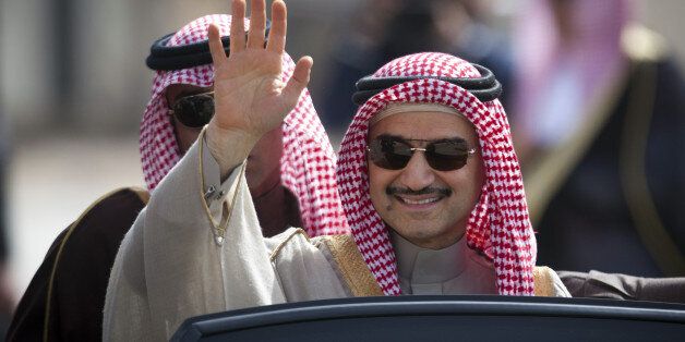 Saudi billionaire Prince Alwaleed bin Talal, waves as he arrives at the headquarters of Palestinian President Mahmoud Abbas in the West Bank city of Ramallah, Tuesday, Feb. 4, 2014. (AP Photo/Majdi Mohammed)