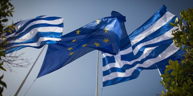 ATHENS, GREECE - JANUARY 23: The national flag of Greece and the flag of the European Union fly above a government building ahead of the general election on Sunday on January 23, 2015 in Athens, Greece. According to the latest opinion polls, the left-wing Syriza party are poised to defeat Prime Minister Antonis Samaras' conservative New Democracy party in the election, which will take place on Sunday. European leaders fear that Greece could abandon the Euro, write off some of its national debt