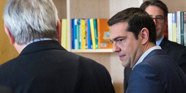 Greek Prime Minister Alexis Tsipras, foreground right, speaks with European Commission President Jean-Claude Juncker prior to a meeting at EU headquarters in Brussels on Wednesday, June 24, 2015. Eurozone finance ministers meet Wednesday to discuss the Greek bailout. (Julien Warnand/Pool Photo via AP)