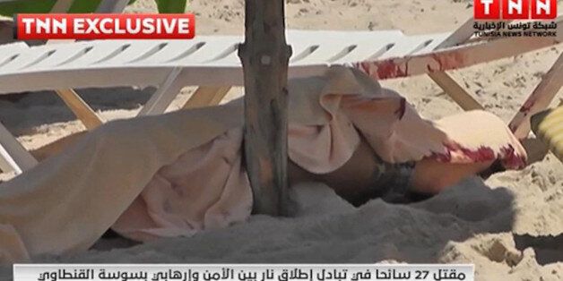 In this screen grab taken from video provided by TNN, a body is covered on a Tunisian beach, in Sousse, Tunisia, Friday June 26, 2015. Two gunmen rushed from the beach into a hotel in the Tunisian resort town of Sousse Friday, killing at least 27 people and wounding six others in the latest attack on the North African country's key tourism industry, the Interior Ministry said. (TNN via AP) MANDATORY CREDIT
