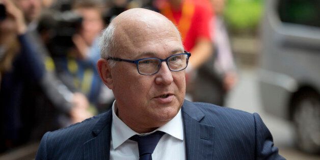 French Finance Minister Michel Sapin arrives for a meeting of eurogroup finance ministers in Brussels on Saturday, June 27, 2015. Anxiety over Greece's future swelled on Saturday after Prime Minister Alexis Tsipras' call to have the people vote on a proposed bailout deal which could increase the risk that the country might fall out of the euro. (AP Photo/Virginia Mayo)