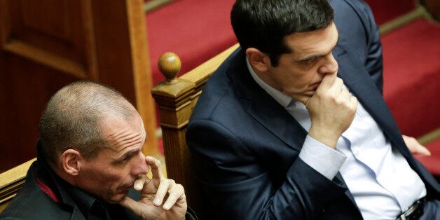 Greece's Prime Minister Alexis Tsipras, right, and Finance Minister Yanis Varoufakis gesture during a Presidential vote in Athens, on Wednesday, Feb. 18, 2015. Greece's parliament elected Prokopis Pavlopoulos, a conservative law professor and veteran politician Wednesday as the country's new president, after he received support from the new left-wing government and main center-right opposition party. (AP Photo/Petros Giannakouris)