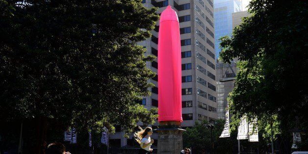 A gaint condom is seen over a heritage-listed obelisk at Hyde Park in Sydney on November 7, 2014. An 18-metre (60-foot) bright pink condom raised eyebrows in Sydney after it was erected over a Sydney landmark as part of a new awareness campaign about HIV. AFP Photo / SAEED KHAN (Photo credit should read SAEED KHAN/AFP/Getty Images)
