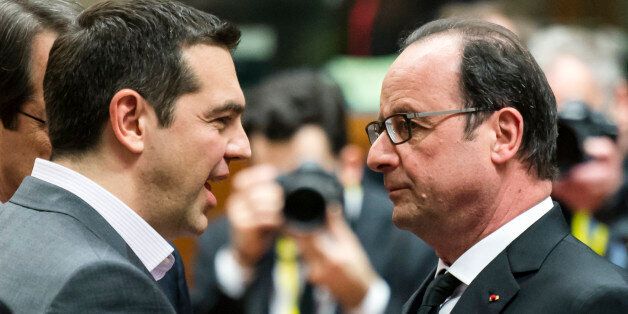 French President Francois Hollande, right, speaks with Greek Prime Minister Alexis Tsipras during a round table meeting at an EU summit in Brussels on Thursday, March 19, 2015. Tensions over Greece's massive financial bailout overshadowed a European Union summit amid fears that the country could accidentally drop out of the euro, triggering a crisis across the currency zone shared by 19 nations. (AP Photo/Geert Vanden Wijngaert)