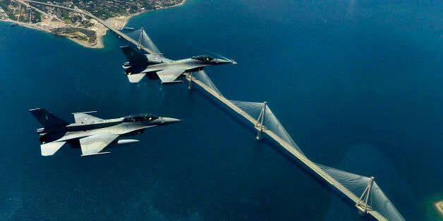 FILE -- In this file photo, a pair of F16 fighters of the Greek airforce fly over the Rio-Antirio bridge in Northwest Peloponnese on Wednesday May 26, 2010. Two similar Greek fighter jets crashed in mid-air during a training exercise south of the island of Crete on Thursday, killing one of the three crew members and leaving the other two injured, the air force said. The F-16 planes - one a single-seater and one a double-seater - had been part of a formation of four planes on a training mission when they collided over the sea off the southern coast of Crete in the early afternoon, the air force said.(AP Photo/Dimitris Manakanatas, file)