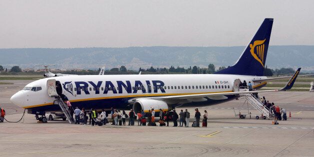 Passengers disembark a Ryanair plane, at the Marseille Provence airport, in Marignane, southern France, Wednesday, May 13, 2015. After more than 10 years of presence at the airport of Marseille, Ryanair welcomed its 10 millionth passenger at the airport. (AP Photo/Claude Paris)