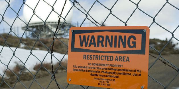 Deadly force is authorized against trespassers on this government property. The sign on this fence is similar to those seen warning visitors to stay clear of the legendary Area 51 military base in Nevada. Photography of that base (and apparently this base, too) is prohibited!