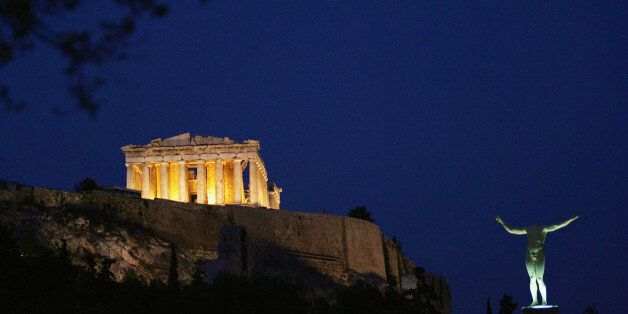 ATHENS - AUGUST 13: The sun sets over the Parthenon on the eve of Athens 2004 Olympic Games during the festivities for the Athens 2004 Summer Olympic Games Opening Ceremony on August 13, 2004 in Athens, Greece. (Photo by Daniel Berehulak/Getty Images)