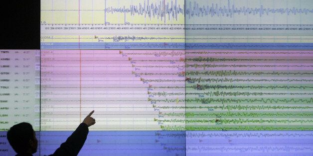A geologist looks at a screen showing the seismograph reading of the powerful earthquake that rocked Sumatra island at the office of Indonesia's meteorological agency in Jakarta, Indonesia, Wednesday, Sept. 30, 2009. The U.S. Geological Survey said the quake had a preliminary magnitude of 7.9, and struck 30 miles (50 kilometers) off the coast of Sumatra. (AP Photo/Irwin Fedriansyah)