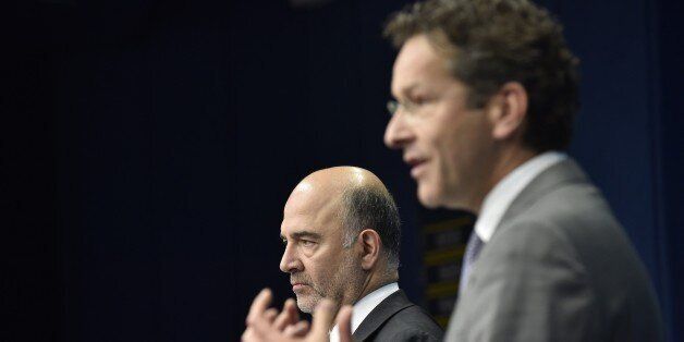 Dutch Finance Minister and president of Eurogroup Jeroen Dijsselbloem (R) gives a joint press with Financial Affairs, Taxation and Customs Commissioner Pierre Moscovici (L) during an Eurogroup Summit meeting on June 22, 2015 at EU Headquarters in Brussels. AFP PHOTO / JOHN THYS (Photo credit should read JOHN THYS/AFP/Getty Images)