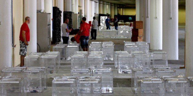 Electoral workers prepare ballot boxes in a warehouse in Thessaloniki on July 2, 2015, ahead of a controversial bailout referendum. Greece's radical left government suggested it would resign if it fails to get its way in a make-or-break referendum July 5 that could decide the country's financial future. AFP PHOTO / SAKIS MITROLIDIS (Photo credit should read SAKIS MITROLIDIS/AFP/Getty Images)