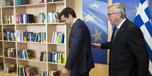 Greece's Prime Minister Alexis Tsipras (L) is welcomed by European Commission President Jean-Claude Juncker (R) ahead of a meeting on Greece, at the European Commission in Brussels,on June 24, 2015, as eurozone finance ministers try to finalise a debt deal and avoid a default by Athens. Greek Prime Minister Alexis Tsipras is set to conduct yet another round of crisis talks with representatives of the country's creditors, ahead of a crucial meeting of eurozone finance ministers where all sides ho