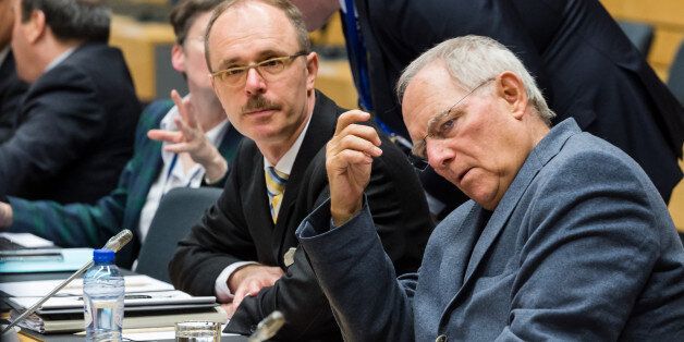 German Finance Minister Wolfgang Schaeuble, right, waits for the start of a meeting of eurogroup finance ministers at the European Council LEX building in Brussels on Monday, June 22, 2015. Heads of state in the eurogroup meet in Brussels on Monday for a special summit to discuss the financial crisis with Greece. (AP Photo/Geert Vanden Wijngaert)