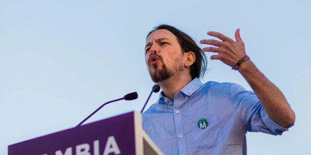 Pablo Iglesias, the leader of Spain's new and growing left wing 'Podemos' (We Can) party speaks during a meeting with supporters for the upcoming local elections in Madrid, Spain, Friday, May 22, 2015. Spain could be set for a political upheaval in key local elections this weekend, with strong signs that voters fed up with economic crisis and corruption scandals may punish both the ruling conservative Popular Party and the leading opposition Socialists. (AP Photo/Andres Kudacki)
