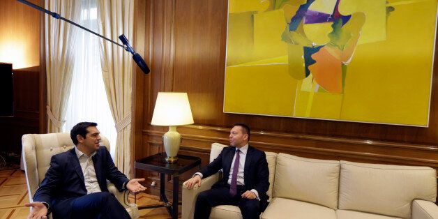 Greece's Prime Minister Alexis Tsipras, left, speaks with Governor of the Bank of Greece Yannis Stournaras at Maximos Mansion in Athens, Friday, March 6, 2015. European Central Bank head Mario Draghi said the ECB