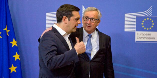 Greek Prime Minister Alexis Tsipras, left, speaks with European Commission President Jean-Claude Juncker as he arrives for a meeting prior to an EU summit at EU headquarters in Brussels on Monday, June 22, 2015. Heads of state in the eurogroup will meet in Brussels on Monday for a special summit to discuss the financial crisis with Greece. (AP Photo/Virginia Mayo)