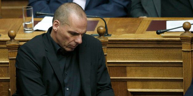 Greece's Finance Minister Yanis Varoufakis looks on his phone during an emergency Parliament session in Athens, on Friday, June 5, 2015. Greek Prime Minister AlexisTsipras said that his government cannot accept