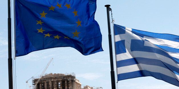 A Greek and a European Union flag billow in the wind as the ruins of the fifth century BC Parthenon temple are seen in the background on the Acropolis hill, Athens, Wednesday, June 3, 2015. Greece's prime minister was heading to high-level meetings in Brussels on Wednesday to try to persuade the country's creditors to accept a proposal that might unlock much-delayed bailout loans and save the country from financial disaster. (AP Photo/Petros Giannakouris)