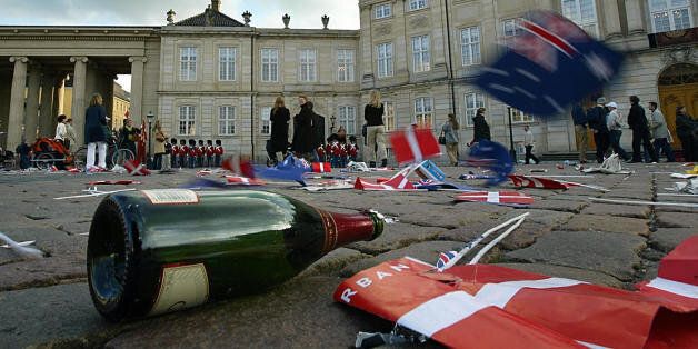 COPENHAGEN, DENMARK: An empty Champagne bottle, Danish and Australian flags litter the courtyard of Amalienborg castle in Copenhagen 14 May 2004, after thousands of wellwishers had greeted Australian Miss Mary Elizabeth Donaldson and Danish Crown Prince Frederik after their wedding ceremony at Copenhagen cathedral. AFP PHOTO / ODD ANDERSEN (Photo credit should read ODD ANDERSEN/AFP/Getty Images)