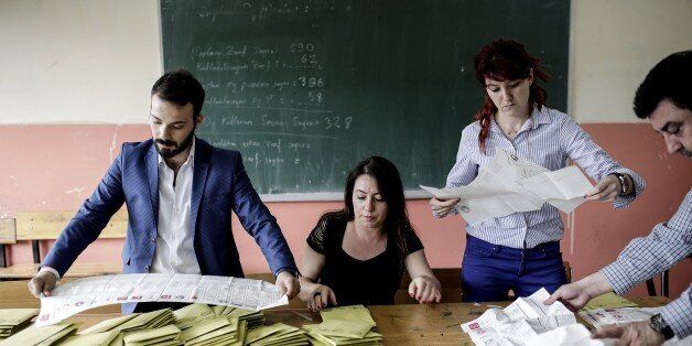 Turkish election officials count ballots after the polls closed, in a school in Istanbul, on June 7, 2015 during the nationwide legislative election. Turkish voters went to the polls on June 7 in a bitterly-contested election set to determine whether President Recep Tayyip Erdogan can tighten his increasingly controversial grip on the country. AFP PHOTO / YASIN AKGUL (Photo credit should read YASIN AKGUL/AFP/Getty Images)