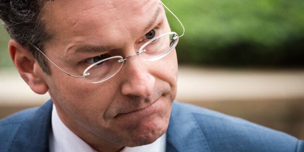 Dutch Finance Minister Jeroen Dijsselbloem talks with journalists as he arrives for a meeting of eurogroup finance ministers at the European Council building in Brussels, Monday March 9, 2015. (AP Photo/Geert Vanden Wijngaert)