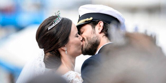 Sweden's Prince Carl Philip kisses his bride, Sofia Hellqvist in a carriage, after their wedding ceremony, in Stockholm, Sweden, Saturday, June 13, 2015. The only son of King Carl XVI Gustaf and Queen Silvia has married his Swedish fiancee in a lavish ceremony in Stockholm. Prince Carl Philip and the former reality starlet and model Sofia Hellqvist, 30, tied the knot Saturday at the Royal Palace chapel before five European queens, a Japanese princess and dozens of other blue-blooded guests. The couple engaged in June 2014. (Pontus Lundahl / TT via AP)
