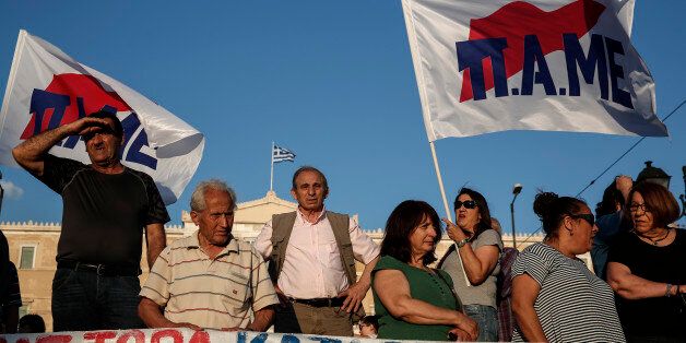 Supporters of Greek Communist party's labor union PAME take part in an anti-austerity rally in front of the parliament at central Syntagma square in Athens, Greece, on Thursday, June 11, 2015. International creditors sent Greek Prime Minister Alexis Tsipras home from a summit Thursday with a clear message: swiftly tone down your demands in the bailout talks over the next week or face financial ruin. (AP Photo/Yorgos Karahalis)