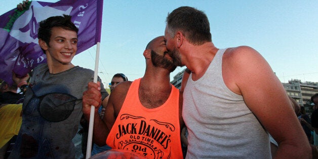 Two men kiss during the annual Gay Pride parade in Athens, Saturday, June 8, 2013. More than 1,000 people took part in the march. (AP Photo/Menelaos Mirilas)3