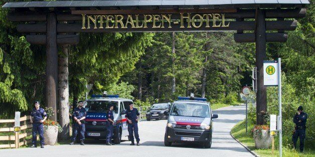 Policemen stand at a checkpoint on a road leading to the Interalpen-Hotel Tirol, venue of the Bilderberg conference, on June 12, 2015 near Telfs, Austria. The Bilderberg group, which brings together international leaders from politics, high finance, business and academia holds its highly exclusive annual meeting in a luxury hotel in the Austrian Alps. AFP PHOTO / CHRISTIAN BRUNA (Photo credit should read CHRISTIAN BRUNA/AFP/Getty Images)