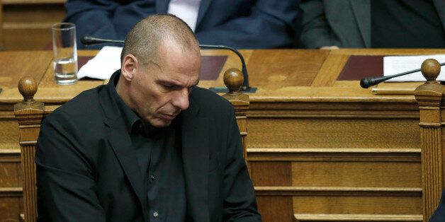 Greece's Finance Minister Yanis Varoufakis looks on his phone during an emergency Parliament session in Athens, on Friday, June 5, 2015. Greek Prime Minister AlexisTsipras said that his government cannot accept