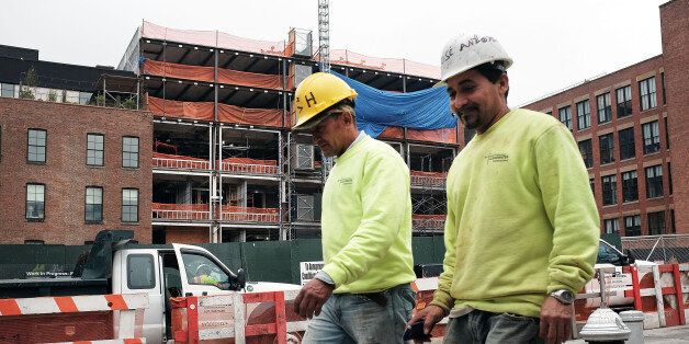 NEW YORK, NY - JUNE 05: Men walk by a construction site in Brooklyn on June 5, 2015 in New York City. New numbers which were released by the government today showed that the U.S. economy gained 280,000 jobs in May and over a million new jobs so far in 2015. May's jobs report dispelled fears that the U.S. economy was contracting after the winter slowdown. (Photo by Spencer Platt/Getty Images)