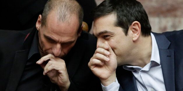 Greece's Prime Minister Alexis Tsipras chats with Greece's Finance Minister Yanis Varoufakis during a Presidential vote in Athens, on Wednesday, Feb. 18, 2015. Greeceâs parliament has elected conservative law professor and veteran politician Prokopis Pavlopoulos as the countryâs next president, after he received support from the new left-wing government and main center-right opposition party.(AP Photo/Petros Giannakouris)