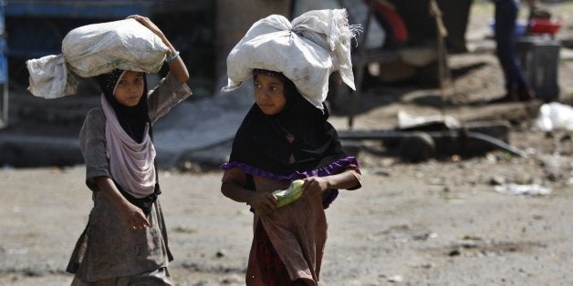 Indian child laborers carry sacks of vegetable leftovers collected from a wholesale market to be sold in their shantytown, on the World Day against Child Labor, on the outskirts of Jammu, India, Friday, June 12, 2015. Despite the country's rapid economic growth, child labor remains widespread in India, where an estimated 13 million children work, with laws meant to keep kids in school and out of the workplace routinely flouted. (AP Photo/Channi Anand)