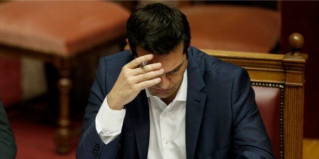 Greece's Prime Minister Alexis Tsipras checks his notes during an emergency Parliament session in Athens, on Friday, June 5, 2015. Tsipras said that his government cannot accept