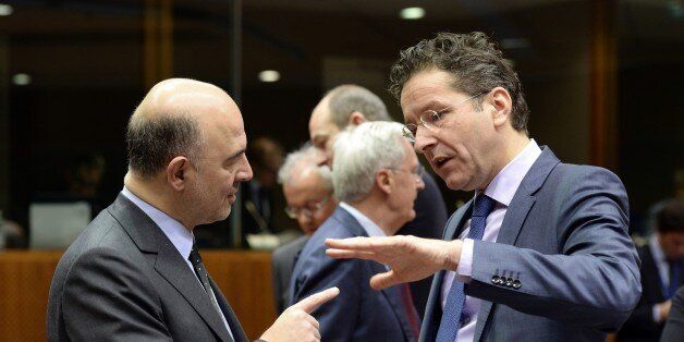 European Union Commissioner for Economic and Financial Affairs Pierre Moscovici (L) speaks with Dutch Finance Minister Jeroen Dijsselbloem prior to the start of a meeting of the Economic and Financial Affairs Council (ECOFIN) at the European Union Council building in Brussels on January 27, 2015. AFP PHOTO / THIERRY CHARLIER (Photo credit should read THIERRY CHARLIER/AFP/Getty Images)