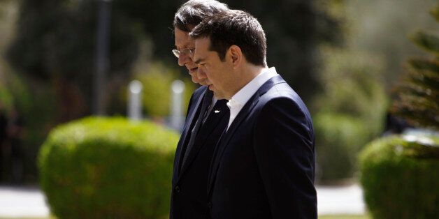 Greek Prime Minister Alexis Tsipras, front, speaks with Cyprus' President Nicos Anastasiades at the presidential palace before a meeting in capital Nicosia, Cyprus Wednesday, April, 29, 2015. Anastasiades and Tsipras are joined by Egyptian President Abdel-Fattah el-Sissi for a summit meeting on the east Mediterranean island to discuss ways of tighter economic and security cooperation between the three countries. The leaders will also discuss unfolding developments in neighboring countries including Yemen, Libya, Syria and Iraq. The meeting follows an initial summit that took place last November in Cairo, Egypt. (AP Photo/Petros Karadjias)