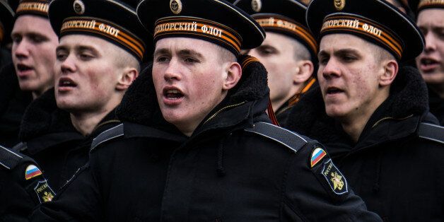 SEVASTOPOL, CRIMEA - MARCH 18: Soldiers sing a song while marching on the streets as people celebrate the first anniversary of the signing of the decree on the annexation of the Crimea by the Russian Federation, on March 18, 2015 in Sevastopol, Crimea. Crimea, an internationally recognised Ukrainian territory with special status, was annexed by the Russian Federation on March 18, 2014. The annexation, which has been widely condemned, took place in the aftermath of the Ukranian revolution. (Photo by Alexander Aksakov/Getty Images)