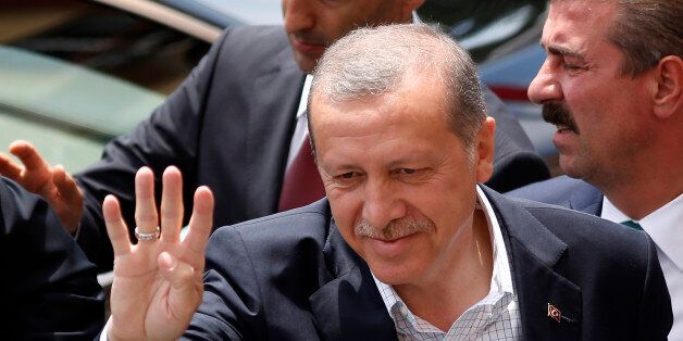 Turkeyâs President Recep Tayyip Erdogan waves to supporters after voting at a polling station in Istanbul, Turkey, Sunday, June 7, 2015. Turks are heading to the polls in a crucial parliamentary election that will determine whether ruling party lawmakers can rewrite the constitution to bolster the powers of Erdogan. All eyes will be on the results for the main Kurdish party, the Kurdish Peoples' Democratic Party, (HDP). If it crosses a 10 percent threshold for entering parliament as a party