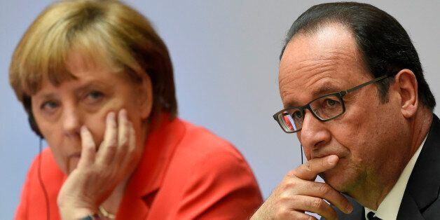 French President Francois Hollande, right, and German Chancellor Angela Merkel attend the Petersberg Climate Dialogue conference in Berlin, Germany, Tuesday, May 19, 2015. The international meeting on climate protection is being held in preparation for the United Nations Climate Change Conference later this year in Paris. (Tobias Schwarz/Pool Photo via AP)