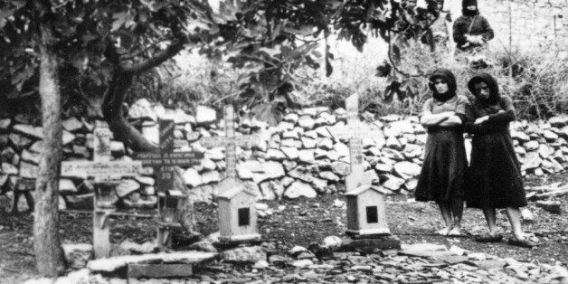 Women standing In the graveyard of Distomo, Greece, where victims of a 1944 Nazi massacre are buried, in this undated picture. In World War II German soldiers killed 214 people as punishment for an attack by partisans. Germany's highest criminal court on Thursday, June 26, 2003 rejected a compensation claim by four Greeks whose relatives were among the victims. (AP Photo)