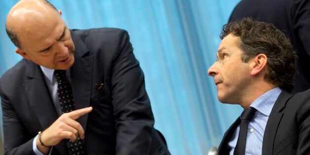 French Finance Minister Pierre Moscovici, left, gestures as he speaks with Dutch Finance Minister Jeroen Dijsselbloem during a round table meeting of eurogroup finance ministers at the EU Council building in Brussels on Thursday, Nov. 14, 2013. Finance ministers at meetings Thursday and Friday in Brussels will discuss how to create a new agency that could restructure bad banks so that taxpayers donât have to pay to bail them out. Itâs one of several banking measures aimed at keeping troubled financial institutions from wrecking government finances and holding back economic growth. (AP Photo/Virginia Mayo)