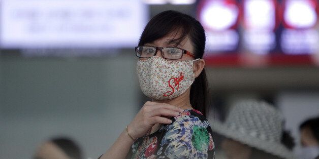 INCHEON, SOUTH KOREA - JUNE 06: A woman wears mask as a precaution against the MERS virus at the Incheon International Airport on June 6, 2015 in Incheon, South Korea. Four deaths from Middle East Respiratory Syndrome (MERS) have been confirmed on June 5, 2015, and the number of confirmed local patients have risen to fifty as of June 6, 2015. (Photo by Chung Sung-Jun/Getty Images)