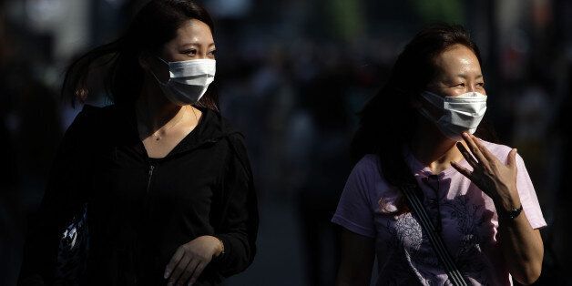 SEOUL, SOUTH KOREA - JUNE 12: People wear masks as a precaution to protect them against the MERS virus at the Myeongdong shopping district on June 12, 2015 in Seoul, South Korea. On June 12, 2015, the South Korea Ministry of Health and Welfare reported four more cases of Middle East Respiratory Syndrome (MERS), adding up to 126 in the total number of people diagnosed with MERS. Meanwhile 1,249 people have been released from isolation, marking the first drop since the outbreak on May 21, 2015. S