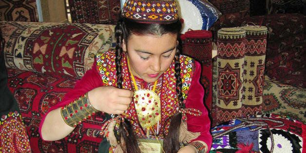 A seamstress embroiders as she sits on carpets during a Day of Turkmen carpets national holiday in Ashgabad on May 25, 2008. AFP PHOTO / STRINGER (Photo credit should read STRINGER/AFP/Getty Images)