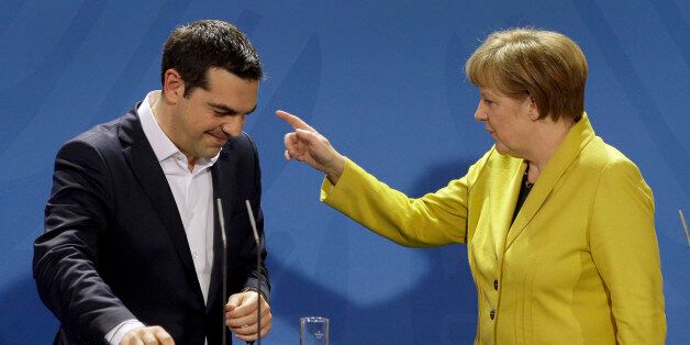 German Chancellor Angela Merkel, right, points as she and the Prime Minister of Greece Alexis Tsipras leave after a press conference as part of a meeting at the chancellery in Berlin, Germany, Monday, March 23, 2015. (AP Photo/Michael Sohn)