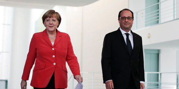 German Chancellor Angela Merkel, left, and French President Francois Hollande arrive at a news conference after a meeting at the chancellery, in Berlin, Germany, Tuesday, May 19, 2015. (AP Photo/Markus Schreiber)