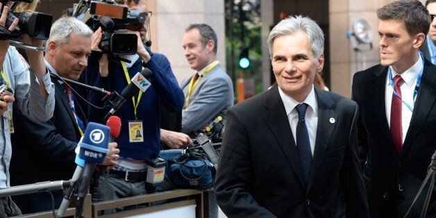 Austria's Chancellor Werner Faymann (R) arrives at the European Council headquarters for an extraordinary summit of European leaders to deal with a worsening migration crisis, on April 23, 2015 in Brussels. European leaders gather on April 23 to consider military action, at an extraordinary summit to deal with a worsening migration crisis after a series of deadly shipwrecks in the Mediterranean. AFP PHOTO / THIERRY CHARLIER (Photo credit should read THIERRY CHARLIER/AFP/Getty Images)