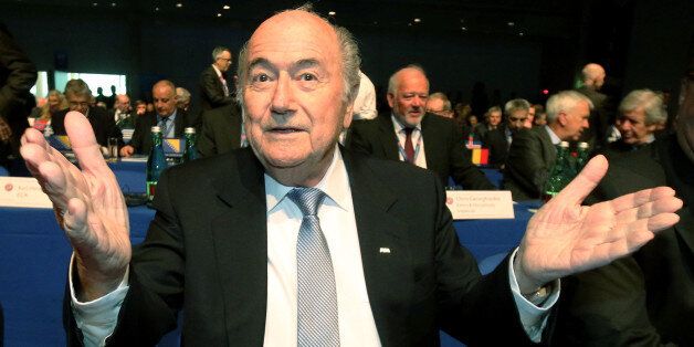 FIFA President Joseph Blatter gestures as he waits for the start of the 39th Ordinary UEFA Congress in Vienna, Austria, Tuesday, March 24, 2015. Blatter hit out at unnamed lawmakers for wanting boycotts of the 2018 World Cup in Russia and the 2022 event in Qatar. (AP Photo/Ronald Zak)